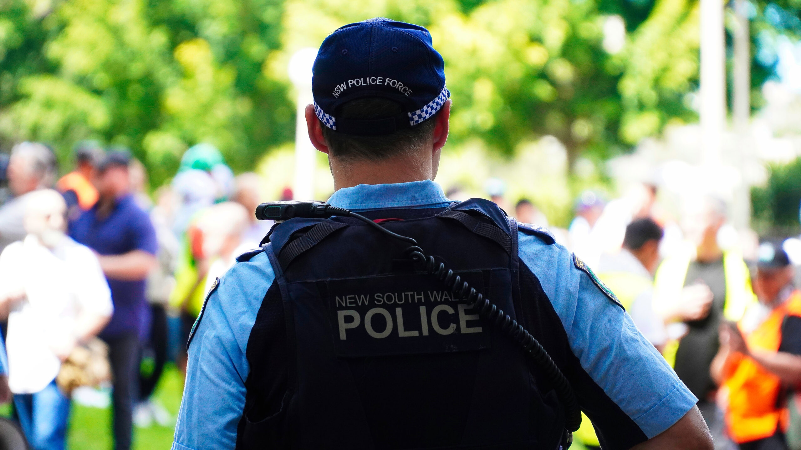 Sydney, NSW Australia - October 6 2024: crime in sydney. Close up of a NSW Police officers uniform sleeve patch and his communication device. australia police