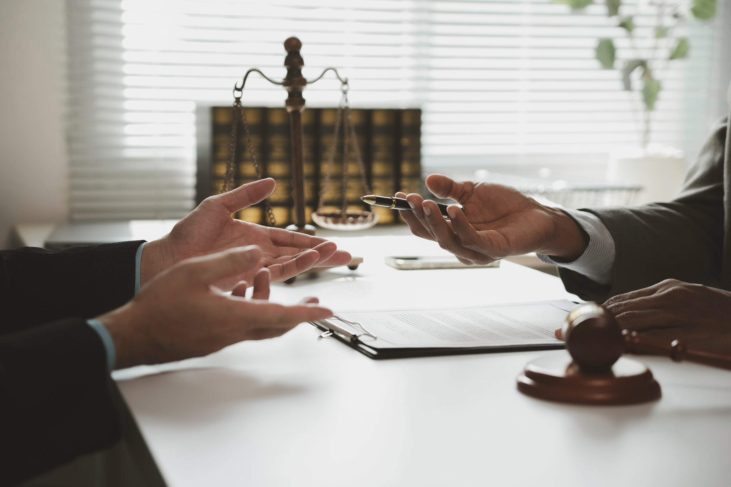 Lawyers discussing legal issues and signing important documents in a courtroom